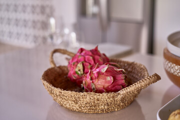 dragon fruit in a wicker basket on the table