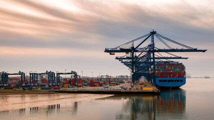Aerial photograph looking through the line of loading gantrys in the early morning mist at...