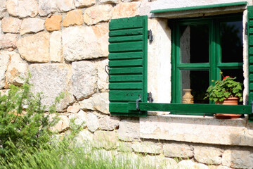 Obraz na płótnie Canvas Traditional wooden window on an old stone house in Dalmatia region, Croatia. 