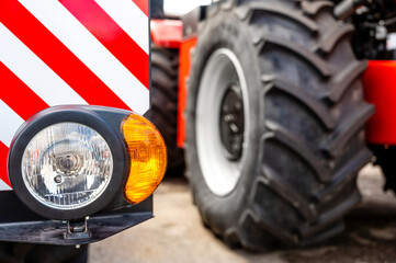 new clean right headlight with reflector on the bumper of the combine