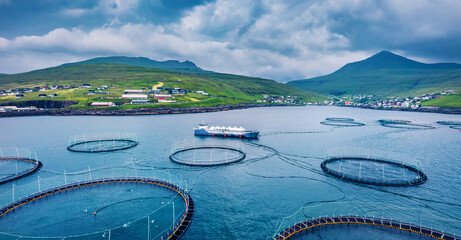 View from flying drone. Trout farm nearby Sandavagur village. Gloomy summer scene of Vagar island. Panoramic morning view of Faroe Islands, Denmark, Europe. Traveling concept background.. © Andrew Mayovskyy
