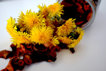 Bouquet of yellow dandelions in a jar on the table