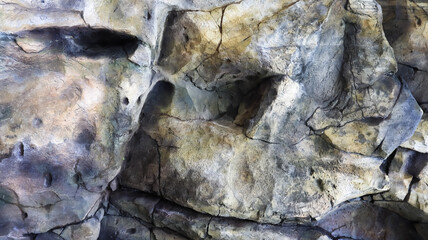 Stone rock texture or background. Gray rocky uneven surface, natural seamless backdrop for design. Copy space