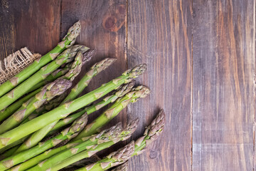 Bunch of fresh green asparagus spears on a rustic wooden table