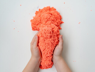 hands little girl playing with kinetic sand. development of fine motor skills. 