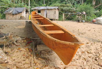 Traditional construction of wooden canoes on Sundy beach, northwest coast of island of Príncipe, ...
