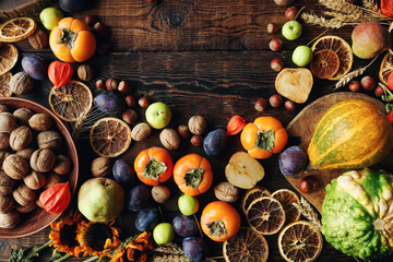 Autumn still-life composition with fresh fruits and vegetables on rustic wooden table
