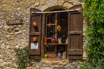 Window with ceramic pots hanging in Provence (France).