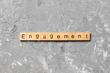 engagement word written on wood block. engagement text on table, concept