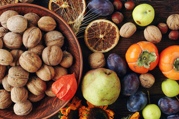 Autumn still-life composition with fresh fruits and vegetables on rustic wooden table