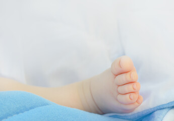 Close-up Newborn baby's foot on blue blanket