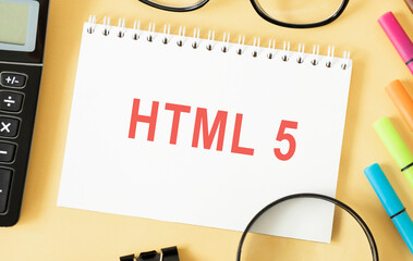 Tablet on notebook with html5 text, with focus to the tip.