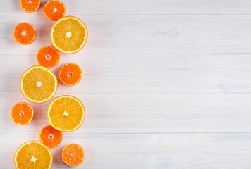 Citruses on white wooden background