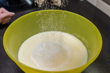 Cook sifts flour for making dough	
