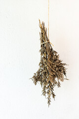 
Bouquet of dried herbs on a white background.