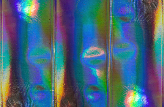 high res full frame macro photo of abstract pastel iridescent holographic foil background with light leaks. holo color wrinkled material. cool glitter surface with shiny rainbow color blocking feel.