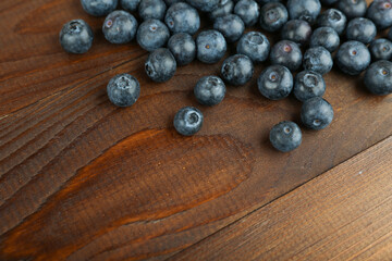 blueberry berries on brown wooden background top view with copy space