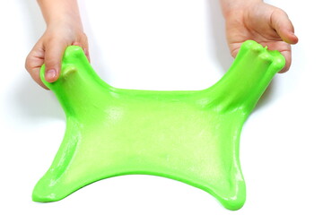 child's hands are playing with a slime on a white background