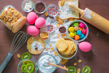 bowls of ingredients needed for baking colorful cupcakes