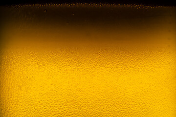 Water drops on glass of beer. Close up beer background.