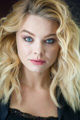 Fototapeta premium Pretty blonde with blue eyes and wavy hair