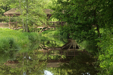 Fototapeta na wymiar Old wooden bridge in Palace Park in Bialowieza in Poland