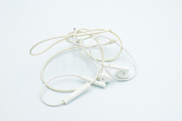 Headphone cable tangled on a white background