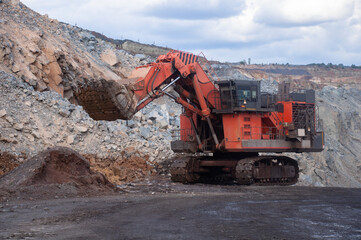 Excavator loads iron ore. mine excavator