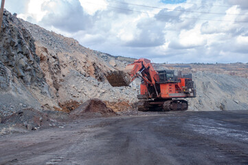 Excavator loads iron ore. mine excavator