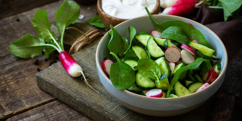 Healthy vegan food. Vegetarian vegetable salad of spinach, radish and fresh cucumber. Banner.
