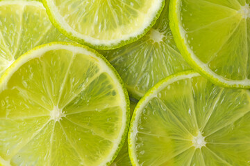 Fototapeta na wymiar fresh and juicy sliced green lime slices close-up, citrus background. beauty and health concept.