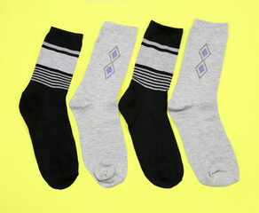 Men's stylish beautiful socks on a yellow background