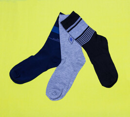 Men's stylish beautiful socks on a yellow background