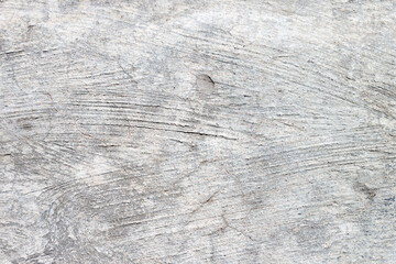A gray concrete wall with an uneven surface. Texture for the design. Background.