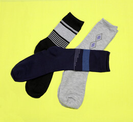 Men's stylish beautiful socks on a yellow background