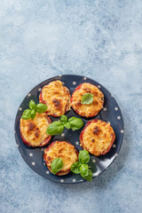Baked eggplant with parmesan cheese, tomatoes and basil