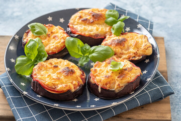 Baked eggplant with parmesan cheese, tomatoes and basil