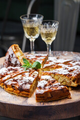 Authentic sponge cake with raisins, cinnamon and apples. Morning atmospheric lighting, fashionable trendy spot soft focus. Preparation for design creative menu. Culinary pastries.