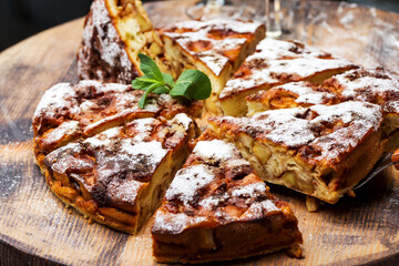Authentic sponge cake with raisins, cinnamon and apples. Morning atmospheric lighting, fashionable...