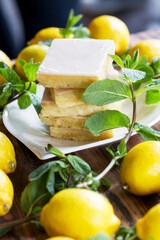 Authentic Shortcake Cake, a lot of fresh yellow lemons and mint. Morning atmospheric lighting, fashionable trendy spot soft focus. Preparation for design creative menu.