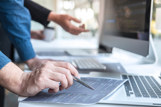 Professional Developer programmer cooperation meeting and brainstorming and programming in website working a software outsourcing and coding technology, writing codes and database