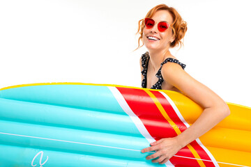 lovely girl in retro glasses holds a surfboard on a white studio background
