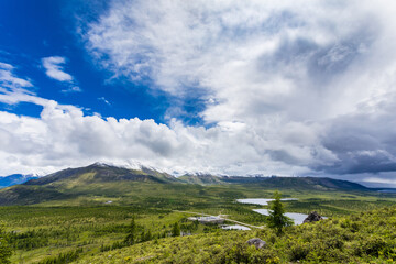 mouth of the Irkut River in the mountains in the summer forest