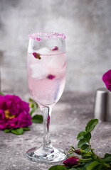 Pink cocktail with champagne and rose syrup