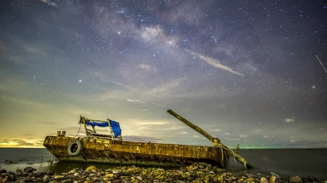 The Milky Way in a depressed atmosphere has a moon rising to the left. And there are clouds with rain and right lightning.