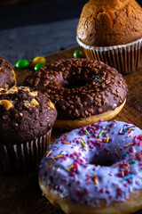 Donuts on a wooden board on a blue concrete background