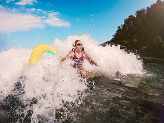 Girl playing in the sea with air mattress