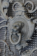 Round metal handle on a metal door with wooden