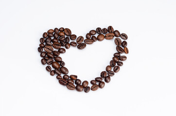 Heart shaped coffee beans on a white background