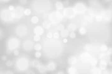 Silver bokeh background. Glowing lights with sparkles. Holiday decorative effect.